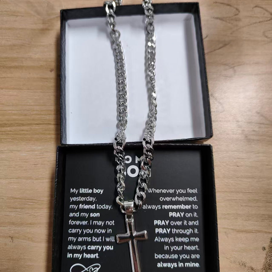 Moissanite cross necklace on a velvet box