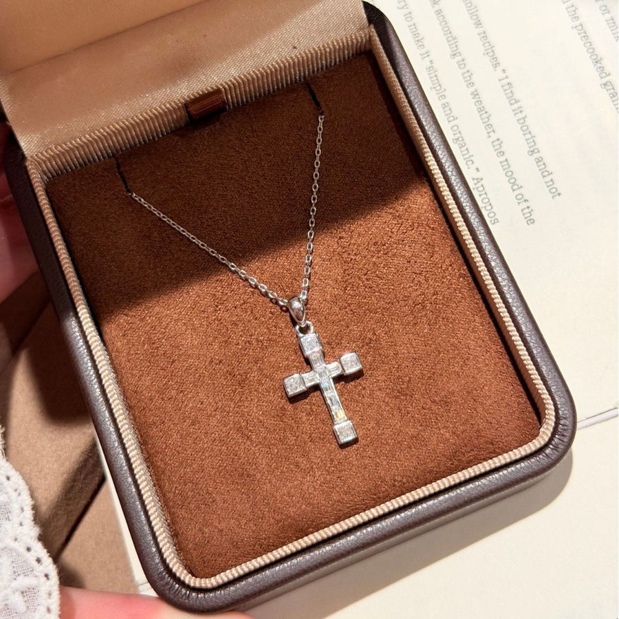 Moissanite cross necklace on a velvet box