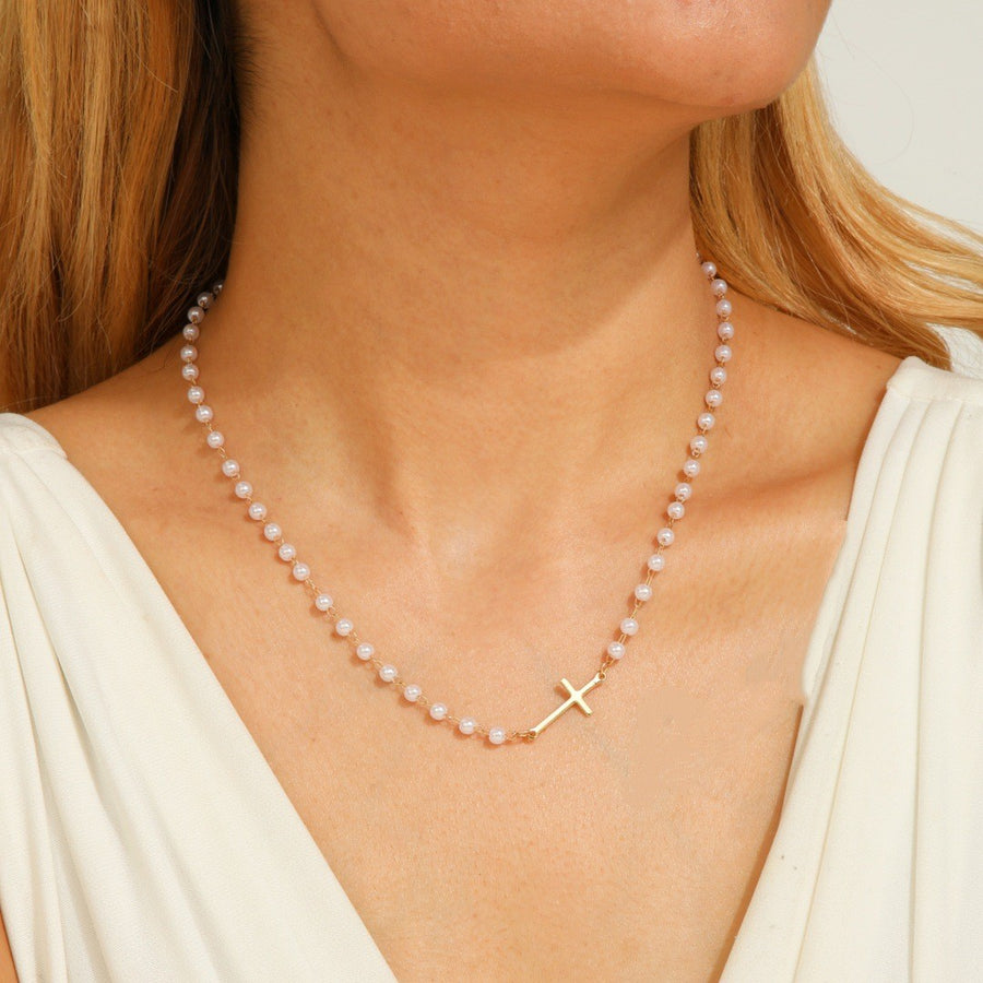 Moissanite cross necklace on a velvet box